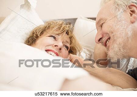 Couple in bed, smiling View Large Photo Image Stock Photography - Couple in bed, smiling. Fotosearch