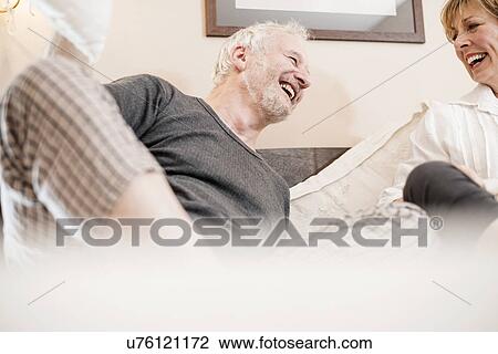 Couple laughing in bed View Large Photo Image Stock Image - Couple laughing in bed. Fotosearch