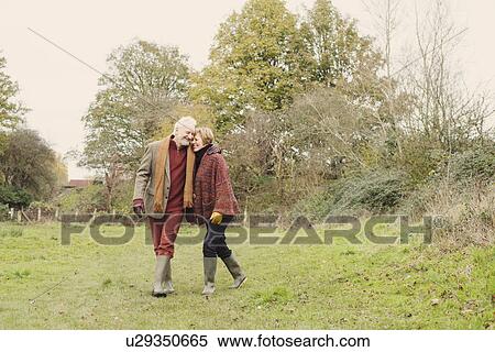 Couple walking in garden View Large Photo Image Stock Photography - Couple walking in garden. Fotosearch