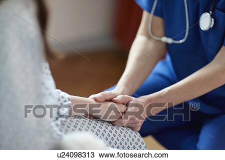 Cropped image of nurse holding patient's hand View Large Photo Image Stock Image - Cropped image of nurse holding patient's hand. Fotosearch