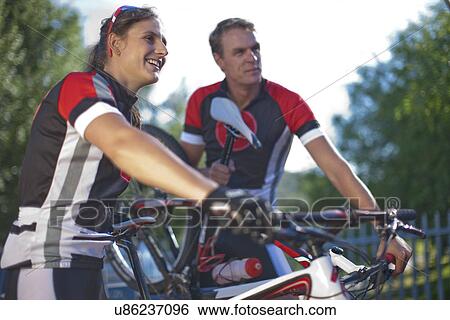 Cyclists taking break in park View Large Photo Image Stock Photograph - Cyclists taking break in park. Fotosearch