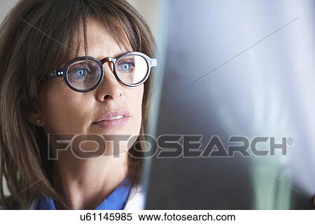 Stock Photography - Doctor looking at xray image of hand. Fotosearch
