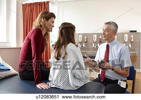 Doctor talking to patient and mother View Large Photo Image Stock Image - Doctor talking to patient and mother. Fotosearch