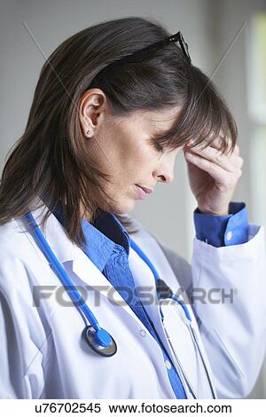 Doctor with hand on head, eyes closed View Large Photo Image Stock Photography - Doctor with hand on head, eyes closed. Fotosearch