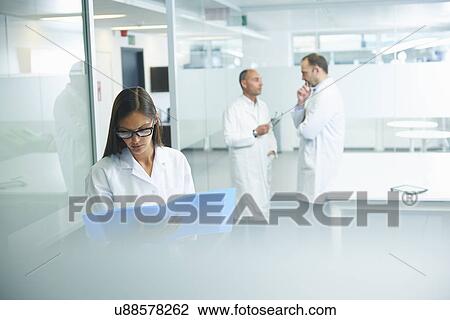 Stock Image - Doctors at work in office. Fotosearch