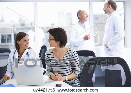 Doctors in brainstorming meeting View Large Photo Image Stock Photograph - Doctors in brainstorming meeting. Fotosearch