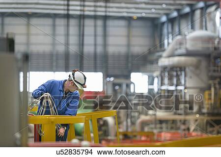Electrical engineer inspecting cables during power station outage View Large Photo Image Picture - Electrical engineer inspecting cables during power station outage. Fotosearch