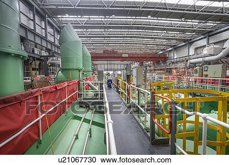 Stock Image - Electrical engineer inspecting cables during power station outage. Fotosearch