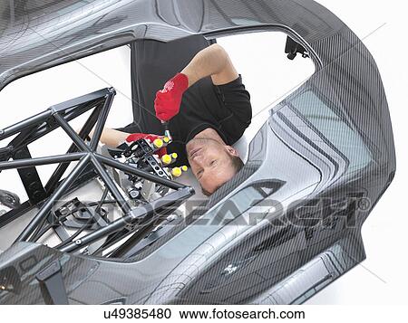 Engineer assembling supercar in sports car factory, overhead view View Large Photo Image Stock Image - Engineer assembling supercar in sports car factory, overhead view. Fotosearch