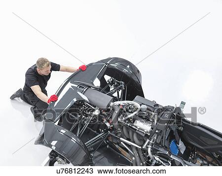Engineer assembling supercar in sports car factory, high angle view View Large Photo Image Stock Image - Engineer assembling supercar in sports car factory, high angle view. Fotosearch