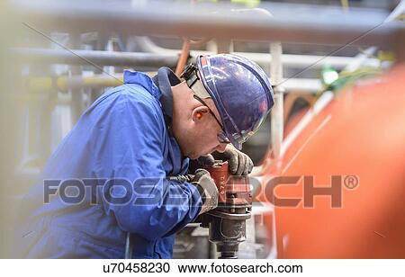 Engineer drilling during power station outage View Large Photo Image Stock Image - Engineer drilling during power station outage. Fotosearch