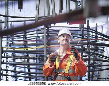 Stock Photo - Engineer inspecting cable expansion in suspension bridge. The Humber Bridge, UK, built in 1981 was the world's largest single-span suspension bridge. Fotosearch