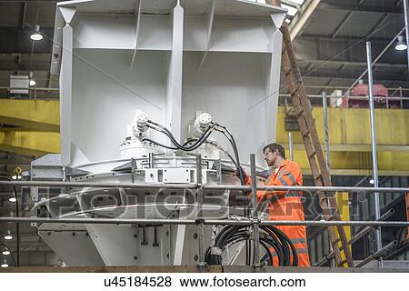 Engineer inspecting marine fabrication used for cable laying View Large Photo Image Stock Photo - Engineer inspecting marine fabrication used for cable laying. Fotosearch
