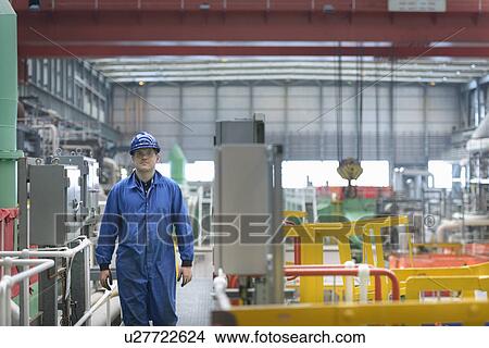 Picture -  Engineer on walkway during power station outage. Fotosearch