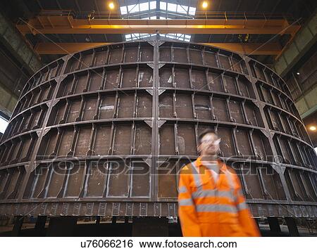 Engineer walking past marine fabrication View Large Photo Image Stock Photograph - Engineer walking past marine fabrication. Fotosearch