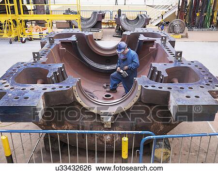 Stock Photograph - Engineer working on turbine housing during power station outage. Fotosearch