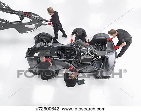 Engineers assemble supercar in sports car factory, overhead view View Large Photo Image Stock Image - Engineers assemble supercar in sports car factory, overhead view. Fotosearch
