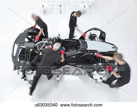Engineers assembling supercar in sports car factory, overhead view View Large Photo Image Stock Image - Engineers assembling supercar in sports car factory, overhead view. Fotosearch