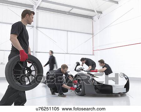 Engineers attend supercar in sports car factory View Large Photo Image Stock Photography - Engineers attend supercar in sports car factory. Fotosearch