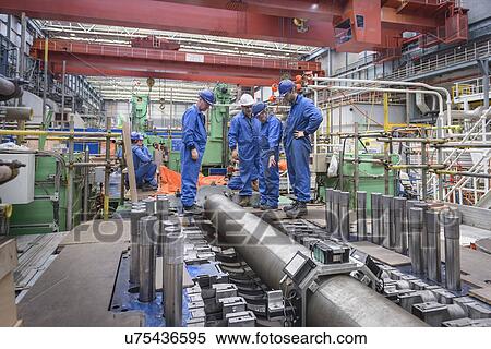Engineers discuss turbine housing repair during power station outage View Large Photo Image Stock Photography - Engineers discuss turbine housing repair during power station outage. Fotosearch