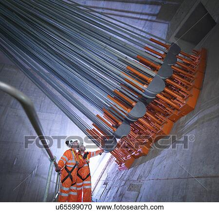 Stock Image - Engineers inspecting cable anchorage in suspension bridge. The Humber Bridge, UK, built in 1981 was the world's largest single-span suspension bridge. Fotosearch
