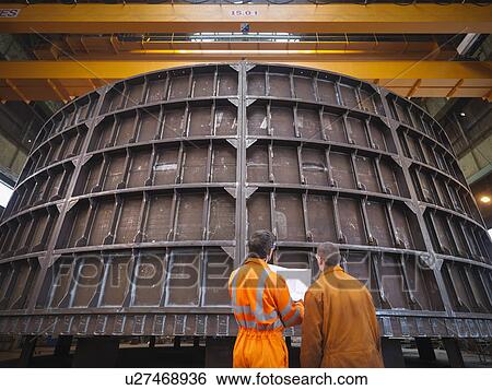 Stock Photograph - Engineers inspecting marine fabrication. Fotosearch