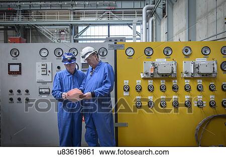 Engineers inspecting notes during power station outage View Large Photo Image Stock Image - Engineers inspecting notes during power station outage. Fotosearch
