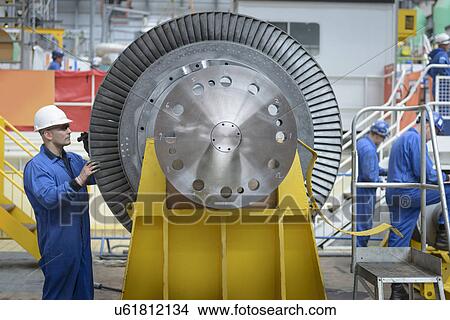 Picture - Engineers inspecting turbine during power station outage. Fotosearch