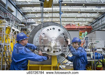 Picture - Engineers inspecting turbine during power station outage. Fotosearch