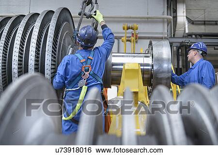 Engineers inspecting turbine during power station outage View Large Photo Image Stock Photograph - Engineers inspecting turbine during power station outage. Fotosearch