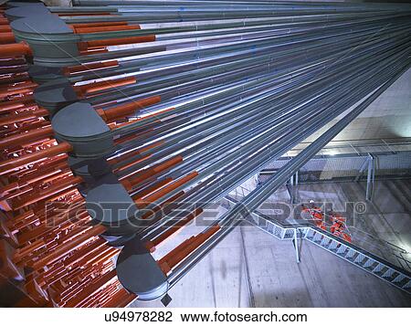 Stock Image - Engineers on staircase with cable anchorage in suspension bridge in foreground. The Humber Bridge, UK, built in 1981 was the world's largest single-span suspension bridge. Fotosearch