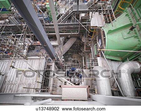 Engineers working deep down in equipment during power station outage, high angle view View Large Photo Image Stock Image - Engineers working deep down in equipment during power station outage, high angle view. Fotosearch