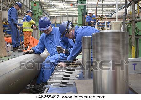Stock Image -  Engineers working on turbine housing repair during power station outage. Fotosearch