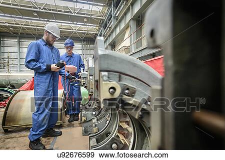 Engineers working on turbine housing repair during power station outage View Large Photo Image Stock Photo - Engineers working on turbine housing repair during power station outage. Fotosearch