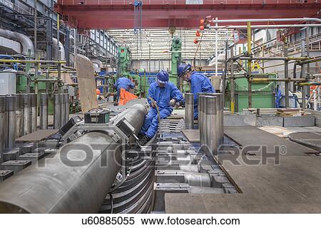 Stock Photography - Engineers working on turbine housing repair during power station outage. Fotosearch