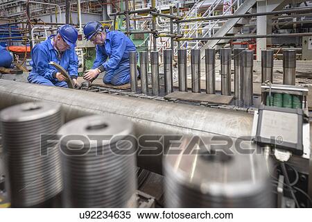 Stock Photography - Engineers working on turbine housing repair during power station outage. Fotosearch