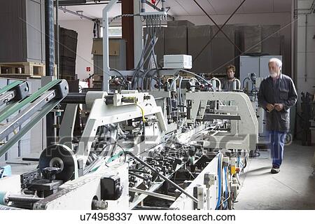 Factory workers machine in cardboard factory View Large Photo Image Stock Photo - Factory workers machine in cardboard factory. Fotosearch