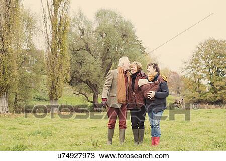 Stock Image - Family walking in park. Fotosearch