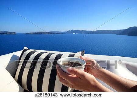 Female hands holding coffee cup on balcony, Santorini, Cyclades Islands, Greece View Large Photo Image Stock Image - Female hands holding coffee cup on balcony, Santorini, Cyclades Islands, Greece. Fotosearch