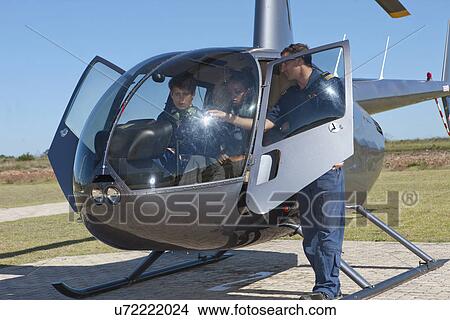 Flight instructor showing student pilots flight deck of helicopter View Large Photo Image Picture - Flight instructor showing student pilots flight deck of helicopter. Fotosearch
