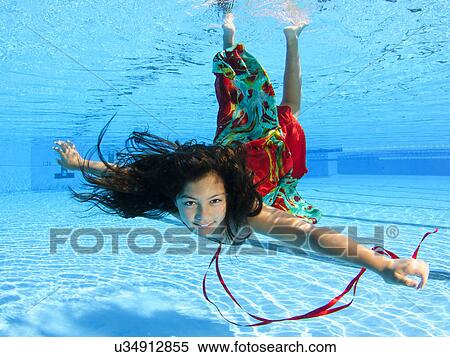 Girl free diving under water in swimming pool View Large Photo Image Stock Photography - Girl free diving under water in swimming pool. Fotosearch
