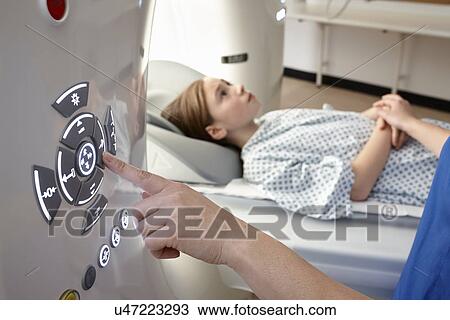 Stock Image - Girl going into CT scanner. Fotosearch
