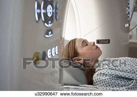 Stock Photo - Girl going into CT scanner. Fotosearch