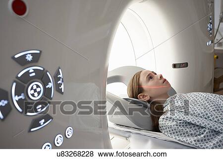 Stock Photo - Girl going into CT scanner. Fotosearch