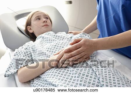 Stock Photography - Girl going into CT scanner. Fotosearch