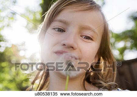 Girl with dandelion clock View Large Photo Image Stock Photography - Girl with dandelion clock. Fotosearch