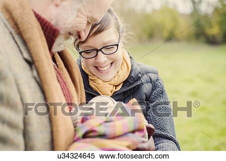 Stock Photography - Grandfather holding grandson, with daughter. Fotosearch
