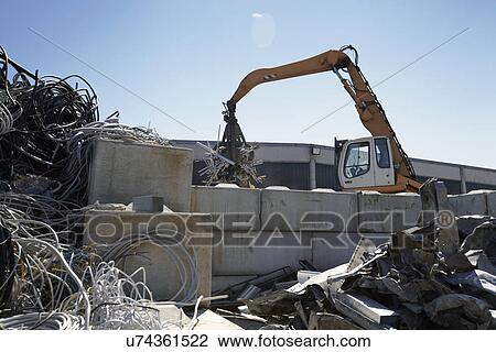 Grapple handler sorting and moving aluminium in scrap yard View Large Photo Image Stock Image - Grapple handler sorting and moving aluminium in scrap yard. Fotosearch