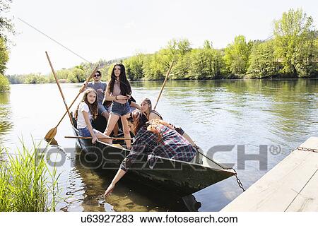 Group of friends in a row boat View Large Photo Image Stock Image - Group of friends in a row boat. Fotosearch
