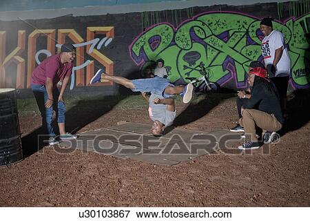 Group of men and boys breakdancing in park at night View Large Photo Image Stock Photo - Group of men and boys breakdancing in park at night. Fotosearch